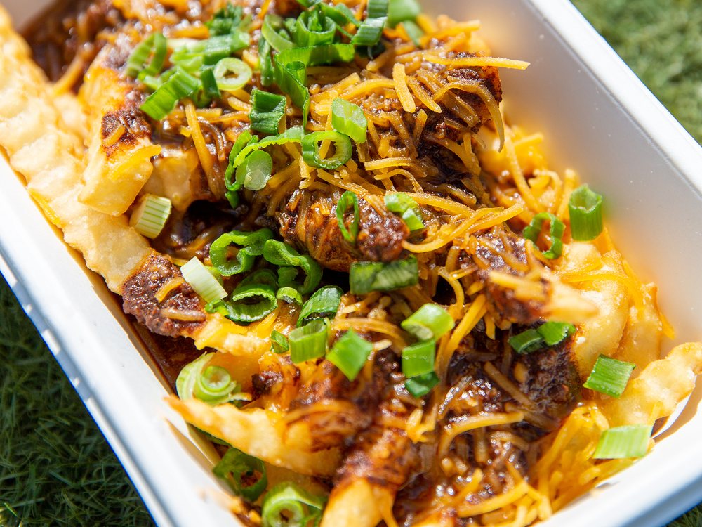 Fifty West chili cheese fries with Cincinnati chili, cheddar, beer cheese, and green onion